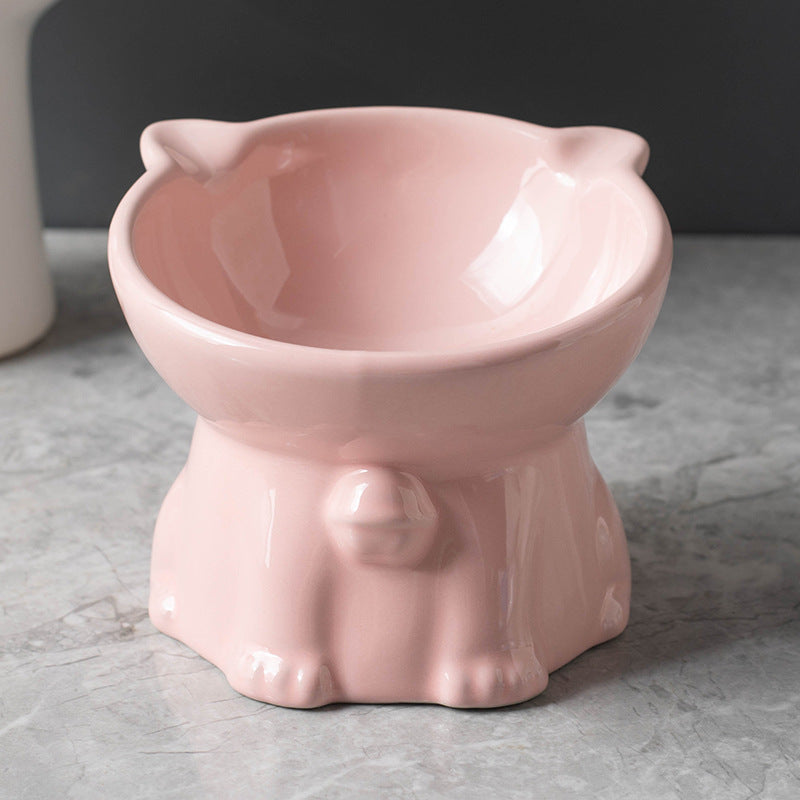 Pink ceramic cat-shaped bowl on a gray surface