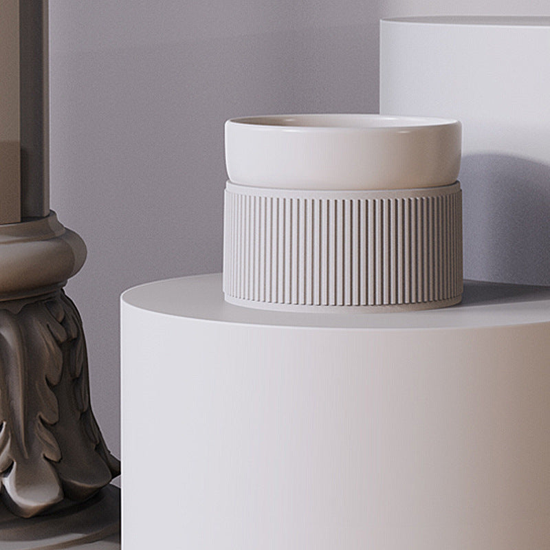 White ceramic pet bowl on a white surface with a neutral background