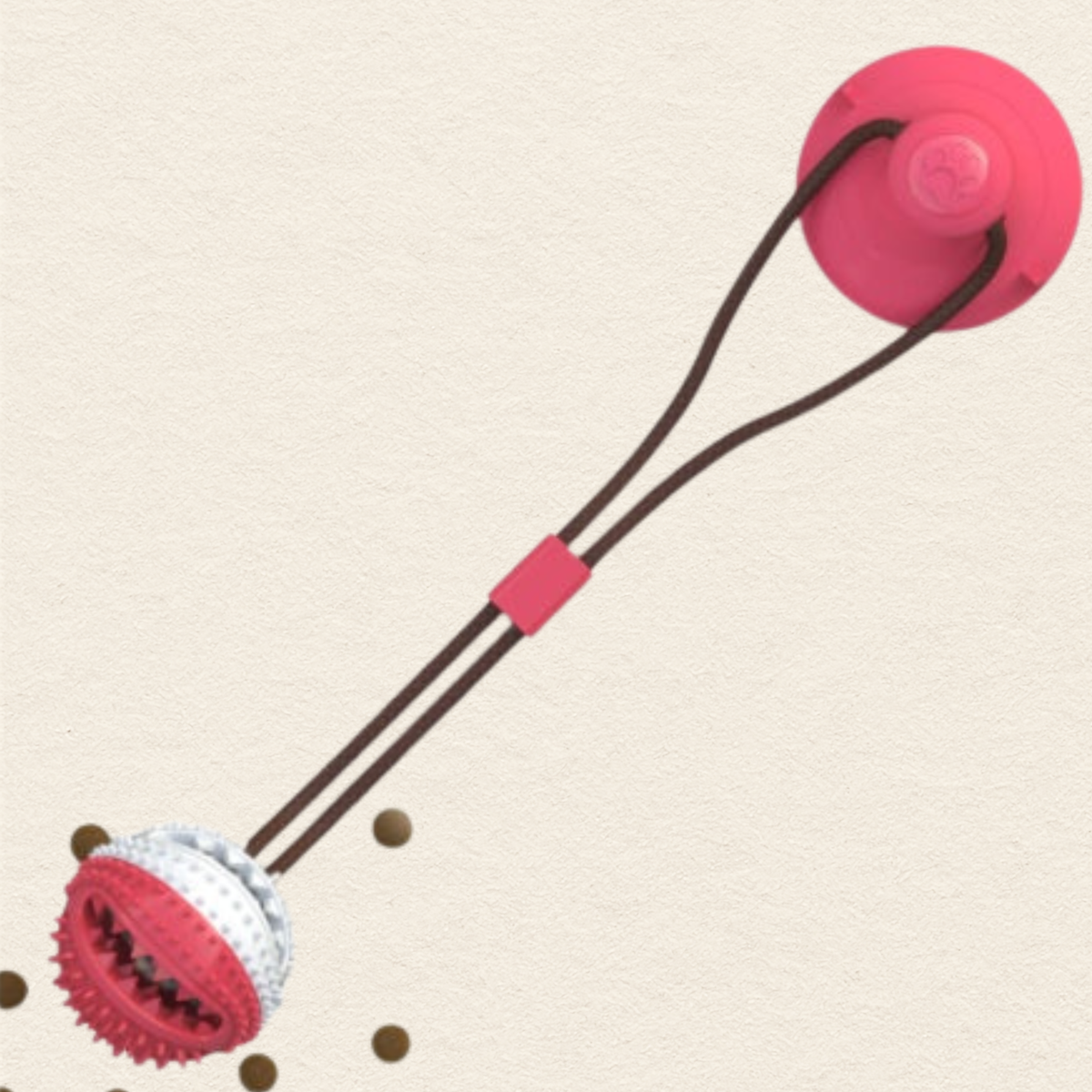A dog tug toy featuring a red suction cup on one end and a textured red and white ball on the other, connected by dark brown elastic cords with a red connector.