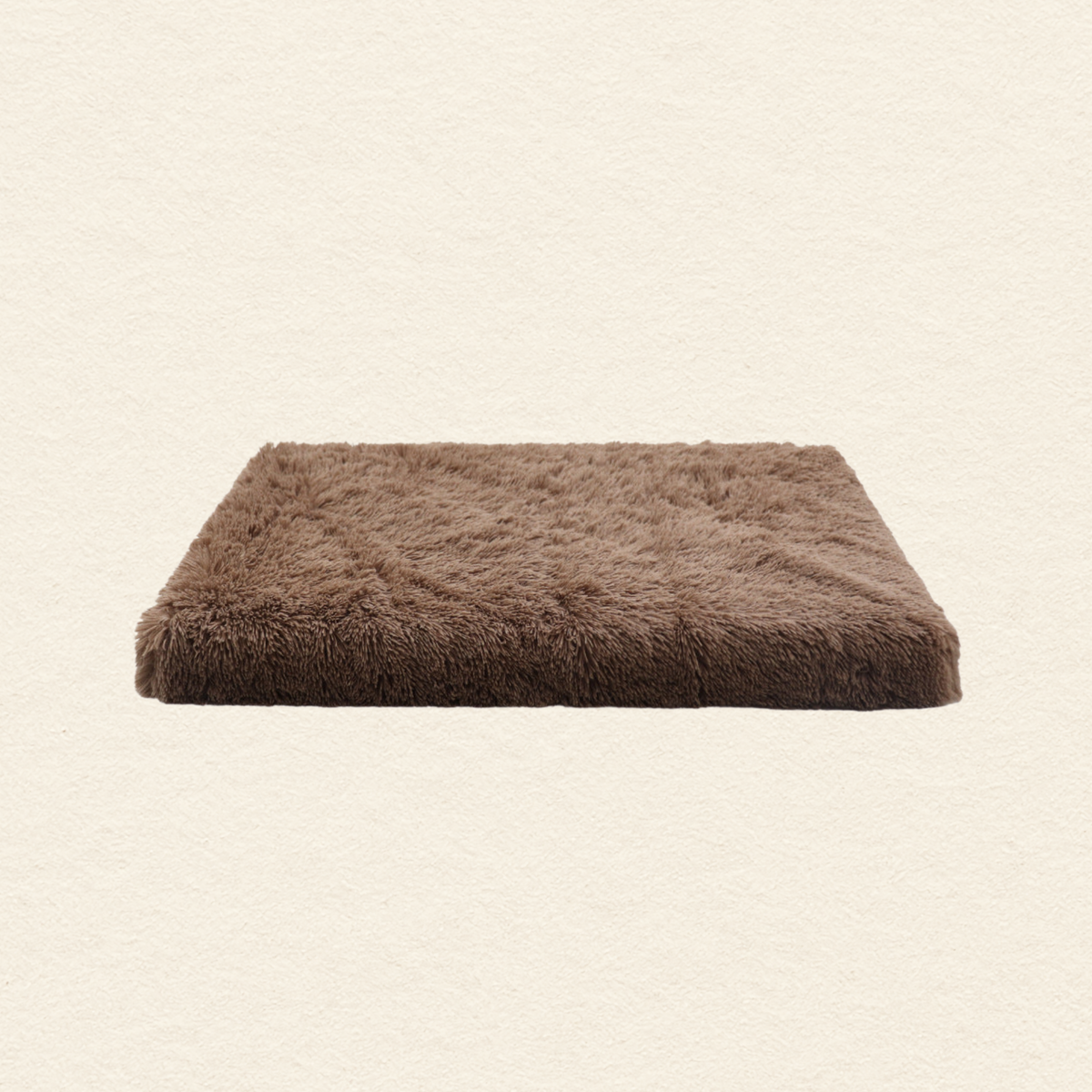 A rectangular brown shaggy faux fur pet bed or cushion, shown from a top-down view on a textured off-white background.