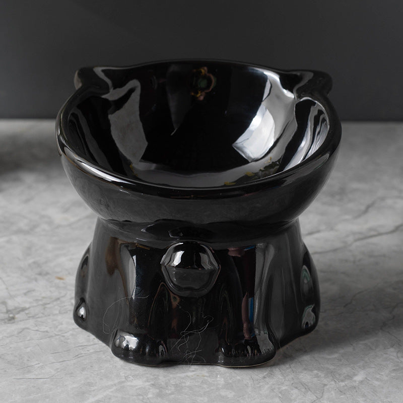 Black ceramic cat-shaped bowl on a gray surface