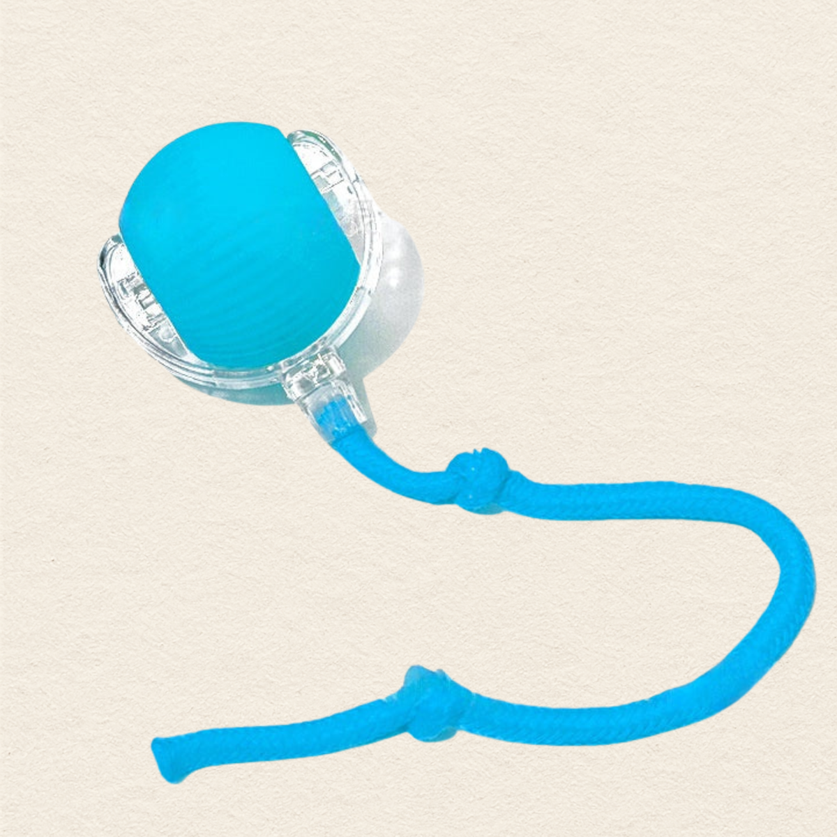 A blue textured silicone cat toy with a clear plastic frame and a blue braided cord, shown on a textured beige background.